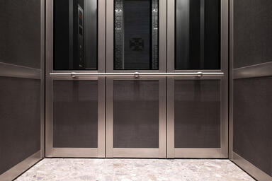 LEVELc-2000 Elevator Interior with upper panels in Grey Mirror Glass and Fused
