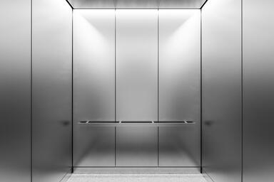 LEVELc-1000 Elevator Interior in Stainless Steel with Seastone finish; ceiling i