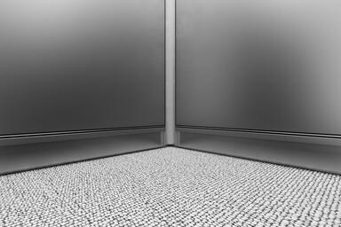 LEVELr Elevator Interior; Cove base in Stainless Steel with Seastone finish