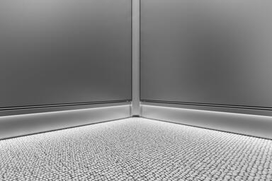 LEVELr Elevator Interior; LED Cove base in Stainless Steel with Seastone finish